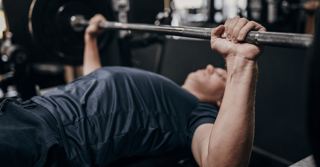 Image illustrating a fitness enthusiast mastering the correct bench press grip for safe and effective training.