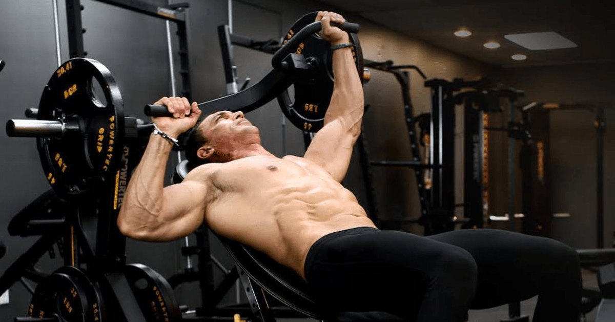 Image of an athlete using an Adjustable Bench Multipress machine during a workout.